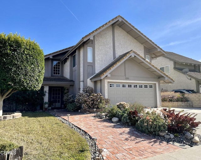 view of front property with a garage and a front yard