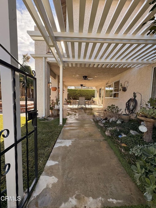 view of patio featuring a pergola and ceiling fan