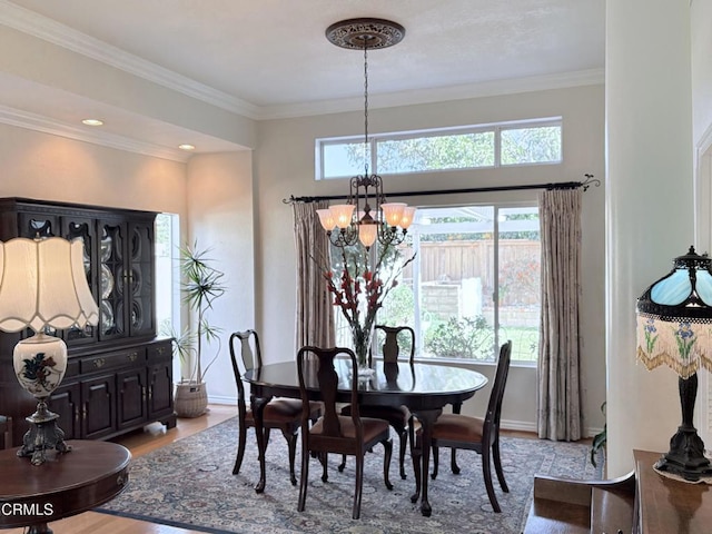 dining area featuring a notable chandelier, plenty of natural light, ornamental molding, and light hardwood / wood-style flooring