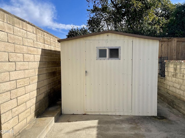 view of shed with fence