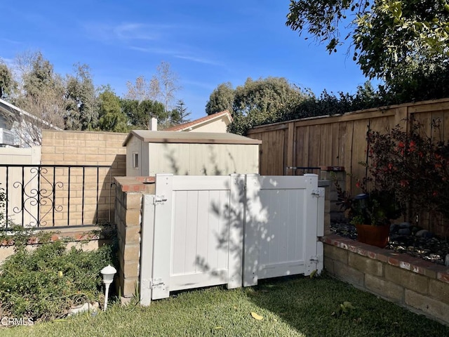 exterior space featuring a fenced backyard and a gate