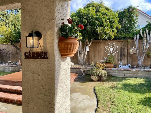 exterior details featuring fence and stucco siding