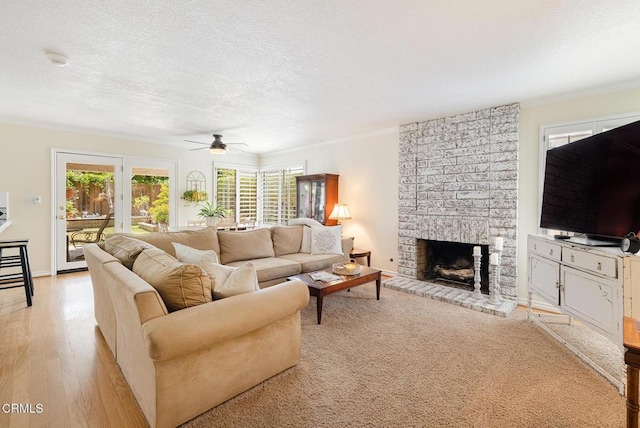 1590 Frazier St, Camarillo, CA 93012 - living area with a fireplace, healthy amount of natural light, ceiling fan, light wood-style flooring, and a textured ceiling