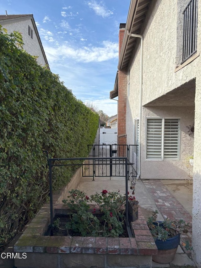 1590 Frazier St, Camarillo, CA 93012 - view of side of home featuring stucco siding, a chimney, and a patio area