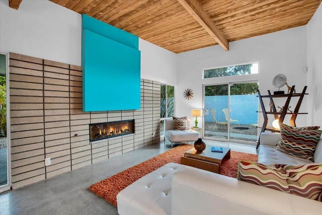 living room featuring a towering ceiling, a fireplace, concrete floors, wooden ceiling, and beam ceiling