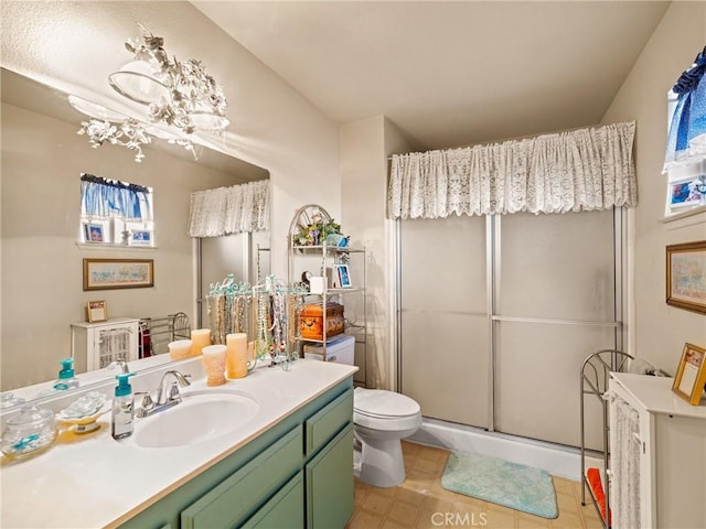 bathroom featuring vanity, toilet, and walk in shower