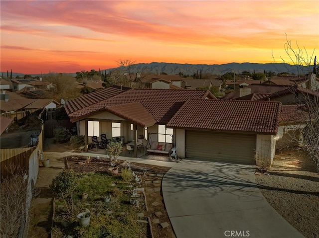 view of front of property featuring a mountain view and a garage