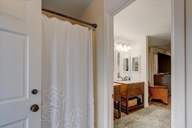 bathroom with vanity, hardwood / wood-style floors, and a shower with shower curtain