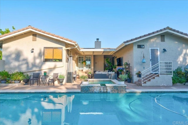 view of swimming pool featuring an in ground hot tub, outdoor lounge area, and a patio area