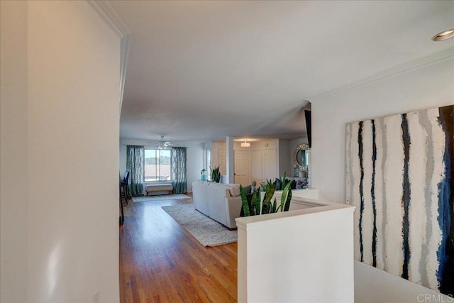 hallway featuring ornamental molding and wood-type flooring