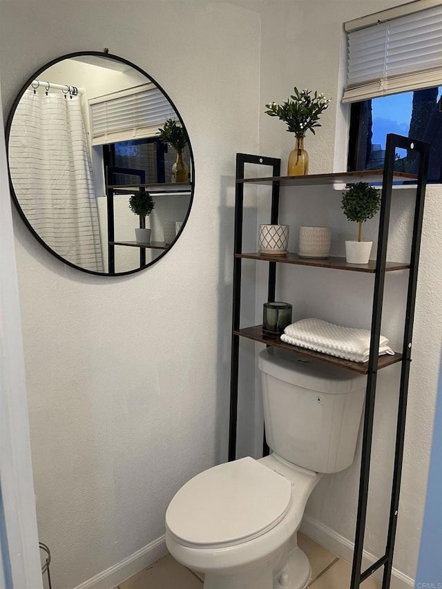 bathroom featuring toilet and tile patterned flooring