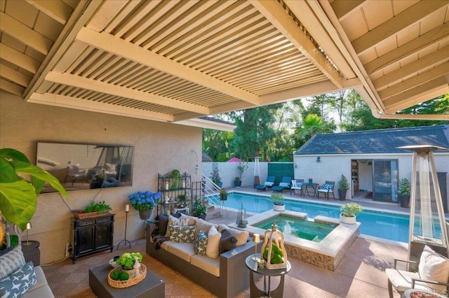 view of pool with an in ground hot tub, outdoor lounge area, and a patio