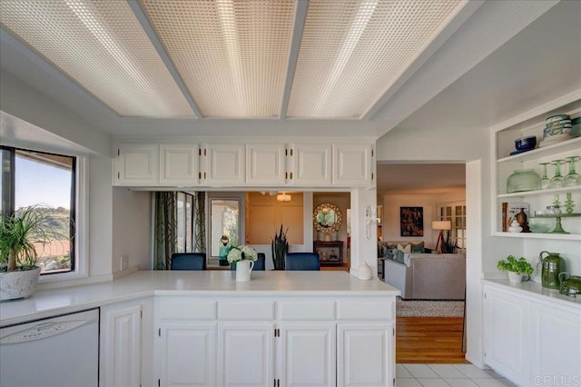 kitchen featuring white cabinetry, dishwasher, and kitchen peninsula