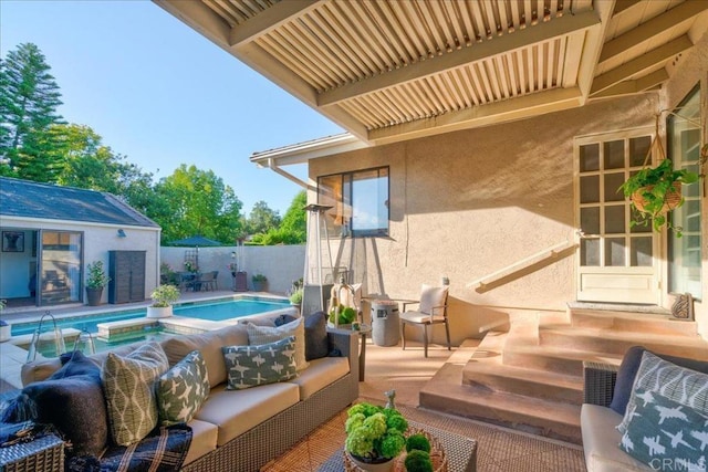 view of patio / terrace with a fenced in pool, an outbuilding, and an outdoor hangout area