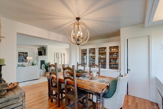 dining room with a notable chandelier and light hardwood / wood-style flooring