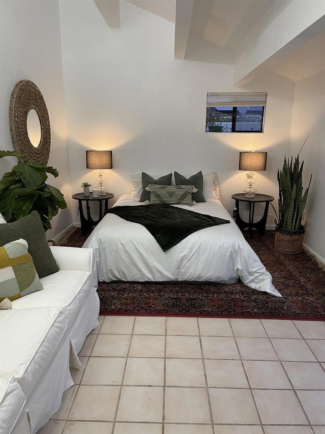 tiled bedroom featuring lofted ceiling with beams