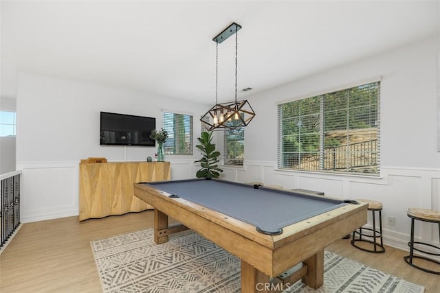 recreation room featuring wood-type flooring, an inviting chandelier, and pool table