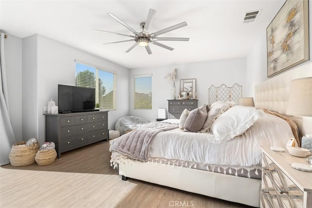 bedroom with ceiling fan and hardwood / wood-style flooring