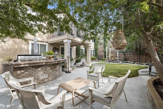 view of patio / terrace with grilling area, an outdoor kitchen, and a balcony