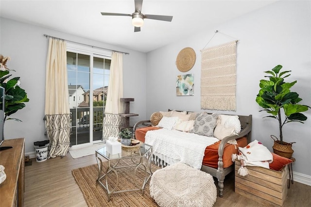 sitting room with ceiling fan and wood-type flooring