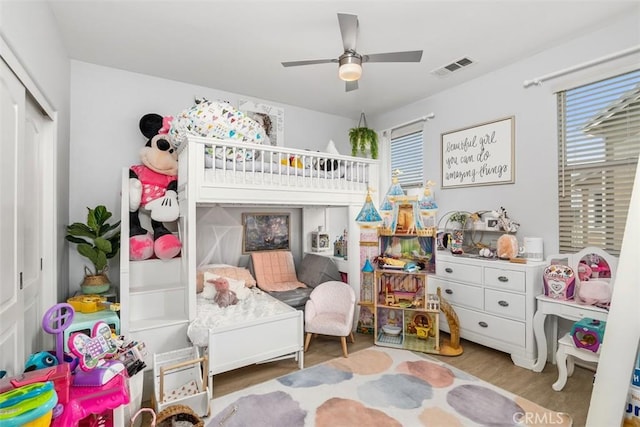 bedroom featuring ceiling fan, a closet, and wood-type flooring