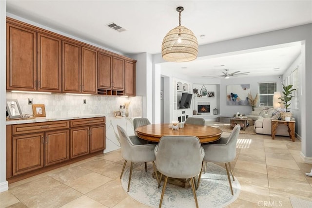 tiled dining room with ceiling fan