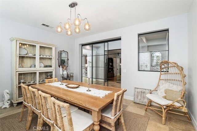 dining area featuring a notable chandelier