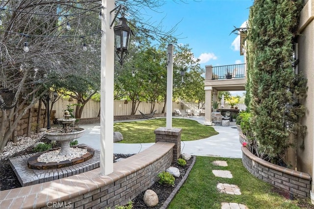 view of yard with a balcony and a patio area