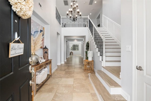 entryway with a notable chandelier and a towering ceiling