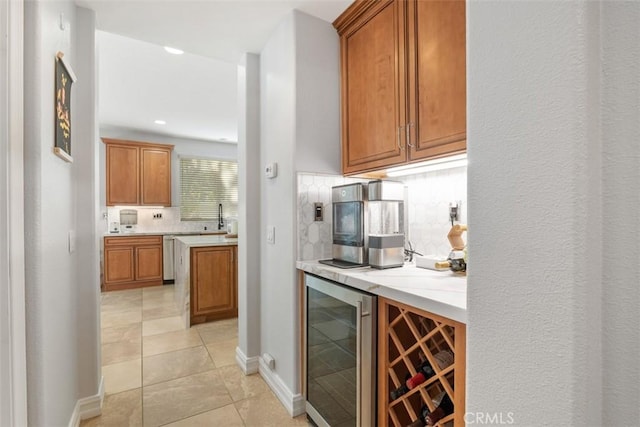 bar with decorative backsplash, light tile patterned floors, and wine cooler