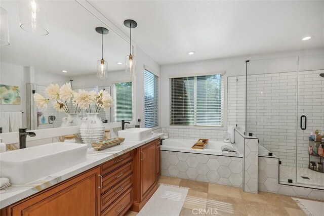 bathroom with separate shower and tub, vanity, and tile patterned floors