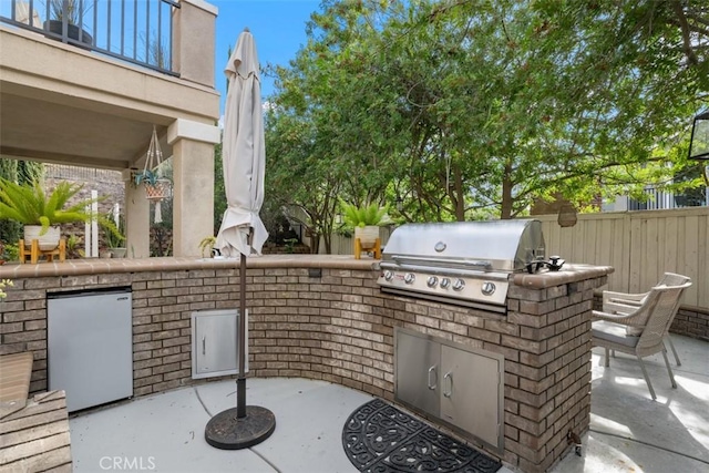 view of patio featuring a balcony, a grill, and area for grilling