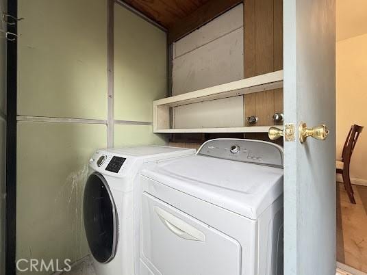 clothes washing area with independent washer and dryer