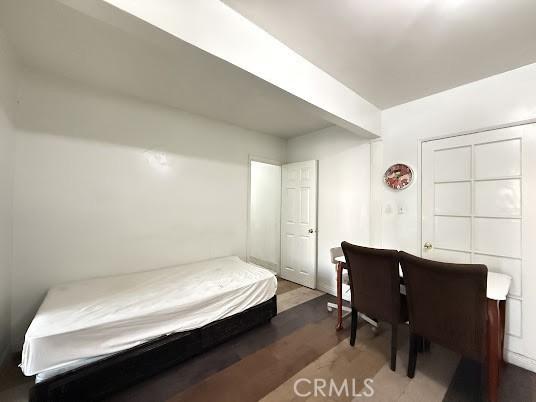 bedroom with dark wood-type flooring