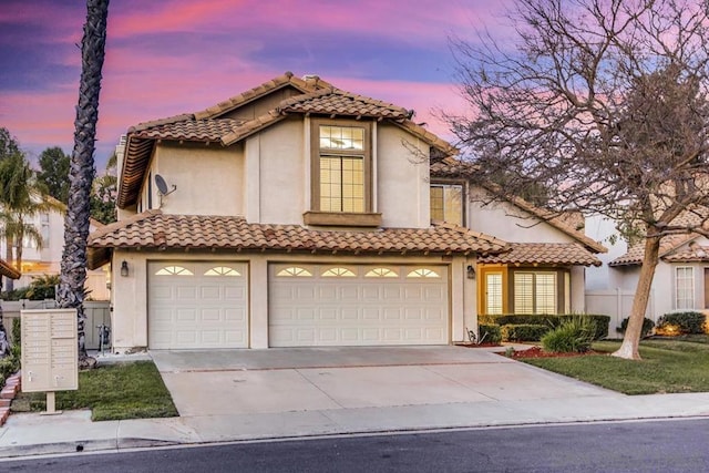 mediterranean / spanish-style house with a garage