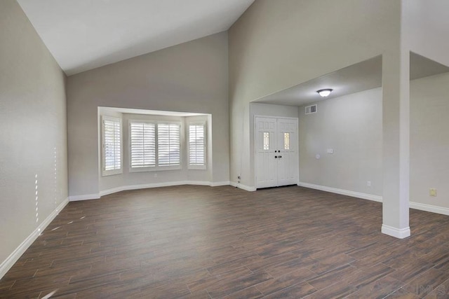 foyer featuring high vaulted ceiling and dark hardwood / wood-style flooring