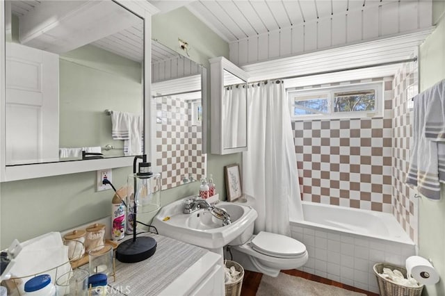 full bathroom with toilet, shower / bath combination with curtain, and sink