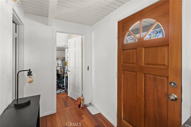 entryway with wooden ceiling, beam ceiling, and dark hardwood / wood-style floors