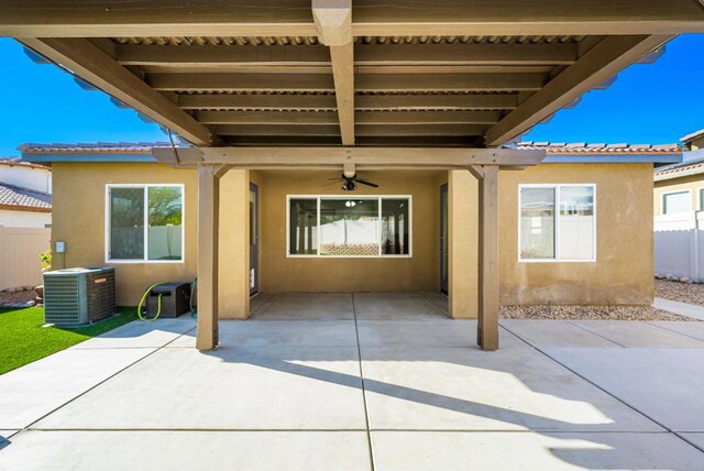 back of property with ceiling fan, cooling unit, and a patio