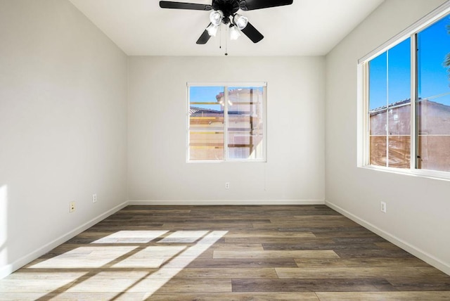 spare room with ceiling fan, plenty of natural light, and hardwood / wood-style flooring