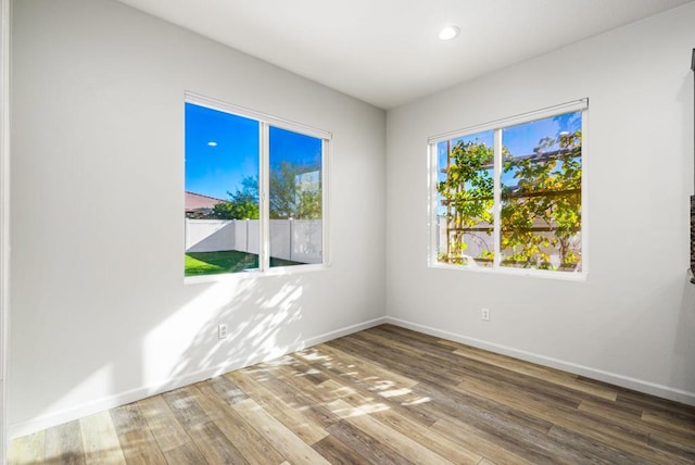 unfurnished room with hardwood / wood-style floors