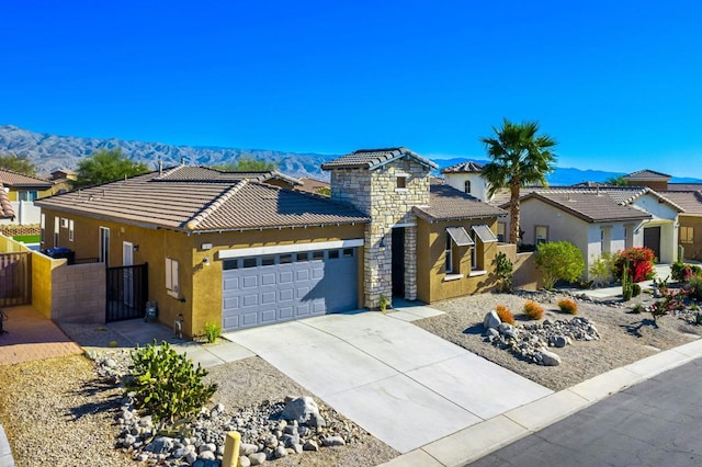 view of front of house featuring a garage and a mountain view