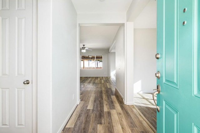 interior space with ceiling fan and dark wood-type flooring