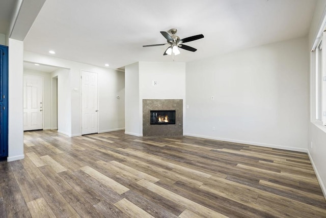 unfurnished living room featuring ceiling fan and wood-type flooring