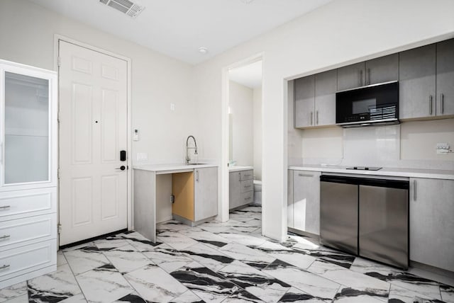 kitchen featuring sink, gray cabinets, and refrigerator