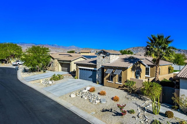 view of front of home with a garage and a mountain view