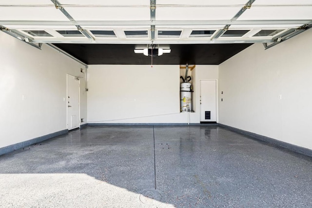 garage with a garage door opener and gas water heater