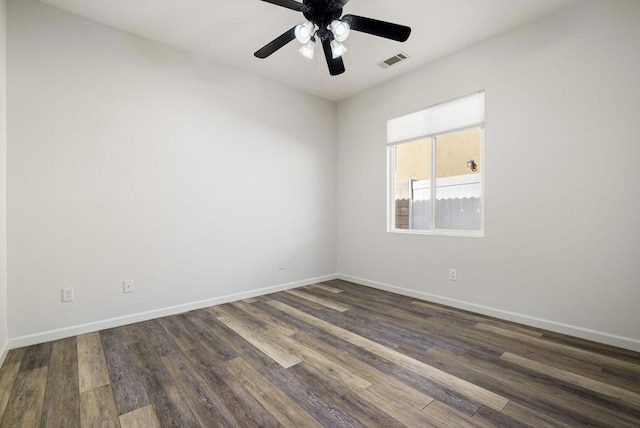 empty room with ceiling fan and dark wood-type flooring