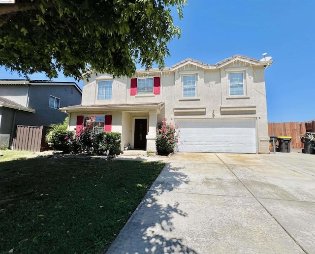 view of front of property featuring a garage and a front lawn