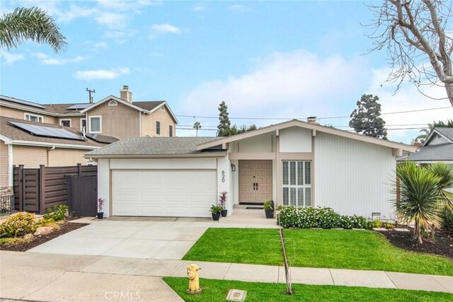 view of front facade with a garage and a front lawn